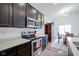 Modern kitchen with stainless steel appliances, ample counter space, and dark wood cabinetry at 6608 W Shoreline Ct, Greenfield, IN 46140