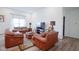Relaxing living room with a decorative rug, a large leather sofa, and a television at 6608 W Shoreline Ct, Greenfield, IN 46140