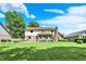 Wide view of the back yard, featuring lush lawn, mature trees, and a spacious deck perfect for outdoor entertaining at 664 N Scott Dr, Greenwood, IN 46142