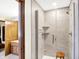 Modern bathroom showcasing a sleek glass-enclosed shower with light colored tile and a wooden stool at 664 N Scott Dr, Greenwood, IN 46142