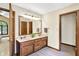 Bathroom with a double sink vanity, large mirror, and wood trim at 664 N Scott Dr, Greenwood, IN 46142
