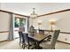 Bright dining room with a dark wood table, six chairs, and a large window providing ample natural light at 664 N Scott Dr, Greenwood, IN 46142