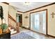 Welcoming foyer with staircase, decorative rug, and a beautiful front door with beveled glass at 664 N Scott Dr, Greenwood, IN 46142