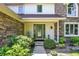 Inviting front entrance with a green door, sidelights, and decorative landscaping at 664 N Scott Dr, Greenwood, IN 46142