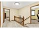 Upstairs hallway with wood banister and neutral carpet at 664 N Scott Dr, Greenwood, IN 46142