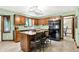 Well-lit kitchen featuring an island with granite countertops and dark wood cabinets and modern stainless steel refrigerator at 664 N Scott Dr, Greenwood, IN 46142
