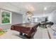 Spacious basement with billiard table, large window, and plenty of room for entertaining or relaxing at 7029 Kingswood Cir, Indianapolis, IN 46256