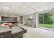 Large basement with a walkout to the backyard, a sectional sofa, and a recreation area at 7029 Kingswood Cir, Indianapolis, IN 46256