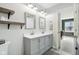 Bathroom featuring double sinks with gray cabinetry and sleek fixtures, combining style and functionality at 7029 Kingswood Cir, Indianapolis, IN 46256