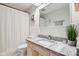 Bathroom featuring white tile walls, patterned floors, and pink vanity with granite countertop at 7029 Kingswood Cir, Indianapolis, IN 46256