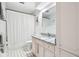 Cozy bathroom featuring white tile walls, patterned floors, and pink vanity with granite countertop at 7029 Kingswood Cir, Indianapolis, IN 46256