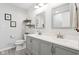 Bathroom featuring double sinks with gray cabinetry and sleek fixtures, combining style and functionality at 7029 Kingswood Cir, Indianapolis, IN 46256