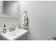 Simple bathroom featuring a white sink, vanity, mirror, and neutral color scheme at 7029 Kingswood Cir, Indianapolis, IN 46256