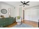 Bright Bedroom with hardwood floors, stylish green dresser, and comfortable reading chair at 7029 Kingswood Cir, Indianapolis, IN 46256