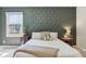 Stylish bedroom featuring a decorative wall design, creating a modern, cozy retreat at 7029 Kingswood Cir, Indianapolis, IN 46256