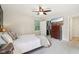 Bright bedroom with a ceiling fan, closet, TV and dresser provides ample storage and entertainment at 7029 Kingswood Cir, Indianapolis, IN 46256