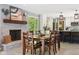 Open dining room and kitchen featuring a brick fireplace and wood accents at 7029 Kingswood Cir, Indianapolis, IN 46256