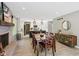 Open-concept dining room with kitchen view and modern lighting fixtures at 7029 Kingswood Cir, Indianapolis, IN 46256