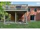 Rear exterior view with a covered deck, highlighting the home's structure and outdoor features at 7029 Kingswood Cir, Indianapolis, IN 46256