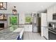 Bright kitchen with white cabinets, stainless steel appliances, granite counters, and farmhouse sink at 7029 Kingswood Cir, Indianapolis, IN 46256