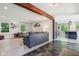 Open-concept living room with stylish decor, wood beam accent, and seamless flow to kitchen and hallway at 7029 Kingswood Cir, Indianapolis, IN 46256