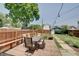 Backyard featuring patio and dining set surrounded by a wooden fence and lawn at 712 Orange St, Indianapolis, IN 46203