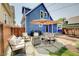 Backyard patio featuring outdoor seating area with comfortable furniture and shade umbrella at 712 Orange St, Indianapolis, IN 46203