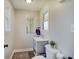 Cozy bathroom featuring a gray vanity, hardwood floors, and natural light from the window at 712 Orange St, Indianapolis, IN 46203