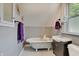 Cozy bathroom with a clawfoot tub, modern vanity, and stylish gray subway tile at 712 Orange St, Indianapolis, IN 46203