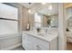 Bathroom featuring double sinks, neutral walls, and a large vanity mirror at 712 Orange St, Indianapolis, IN 46203