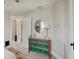Bedroom featuring a vanity with round mirror, neutral walls, and cozy carpet at 712 Orange St, Indianapolis, IN 46203