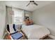 Bright bedroom with neutral walls, a comfortable bed, area rug, and a cozy chair with throw blanket at 712 Orange St, Indianapolis, IN 46203
