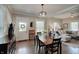 Dining area with hardwood floors and open access to living room with natural light at 712 Orange St, Indianapolis, IN 46203
