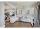 Spacious kitchen with stainless steel appliances, white cabinetry, and an open layout to the living area at 712 Orange St, Indianapolis, IN 46203