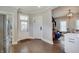 Bright kitchen featuring white cabinetry, wood floors, and an open doorway to the living area at 712 Orange St, Indianapolis, IN 46203