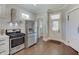 Modern kitchen with stainless steel appliances, white cabinets, and an inviting back door entrance at 712 Orange St, Indianapolis, IN 46203