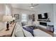 Living room features a large sectional, fireplace, and television with natural light at 712 Orange St, Indianapolis, IN 46203
