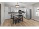 Modern kitchen with stainless steel appliances, bright white cabinets, and an elegant center table at 714 S Keystone Ave, Indianapolis, IN 46203