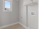 Well-lit laundry room with tile floors, utility hookups, and bright window at 714 S Keystone Ave, Indianapolis, IN 46203