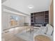 Bright living room with fireplace, sleek hardwood floors, and adjacent outdoor access at 714 S Keystone Ave, Indianapolis, IN 46203