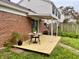 Cozy backyard deck featuring a table, plants, and a charming outdoor seating area at 7392 S Meridian St, Indianapolis, IN 46217