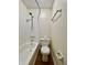 Cozy bathroom featuring a shower-tub combo, white tile, and a wood-look floor at 7392 S Meridian St, Indianapolis, IN 46217