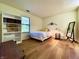 Bright bedroom featuring a comfortable bed, a built-in bookcase, and hardwood floors at 7392 S Meridian St, Indianapolis, IN 46217