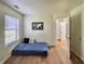 Minimalist bedroom with hardwood floors, a comfortable mattress, and ample natural light at 7392 S Meridian St, Indianapolis, IN 46217