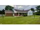 Inviting single-story home featuring brick and siding, plus a well-manicured lawn at 7392 S Meridian St, Indianapolis, IN 46217