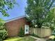 Charming single-Gathering home with brick facade and well-maintained front yard with mature trees at 7392 S Meridian St, Indianapolis, IN 46217