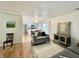 Open-concept living room with hardwood floors and views into kitchen with stainless steel appliances at 7392 S Meridian St, Indianapolis, IN 46217