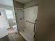 Accessible bathroom featuring a walk-in shower with safety bars, a sink and a window at 7641 E 35Th St, Indianapolis, IN 46226