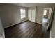 This bedroom features wood flooring, closet, fresh paint and a window for natural light at 7641 E 35Th St, Indianapolis, IN 46226