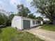 Home with well-kept yard and a gray garage door and window accents, giving it a clean and modern look at 7641 E 35Th St, Indianapolis, IN 46226
